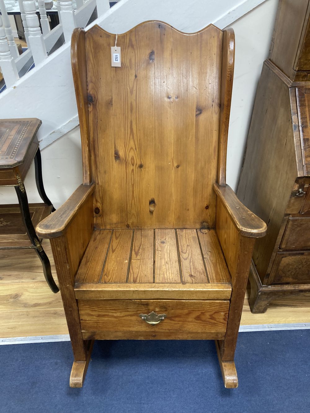 A pitch pine rocking armchair, width 66cm, height 111cm